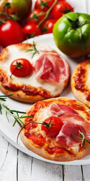 vecteezy_mini-pizza-with-mozzarella-prosciutto-and-tomato_763800