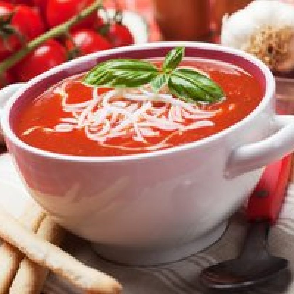 Thick tomato soup with noodles and basil